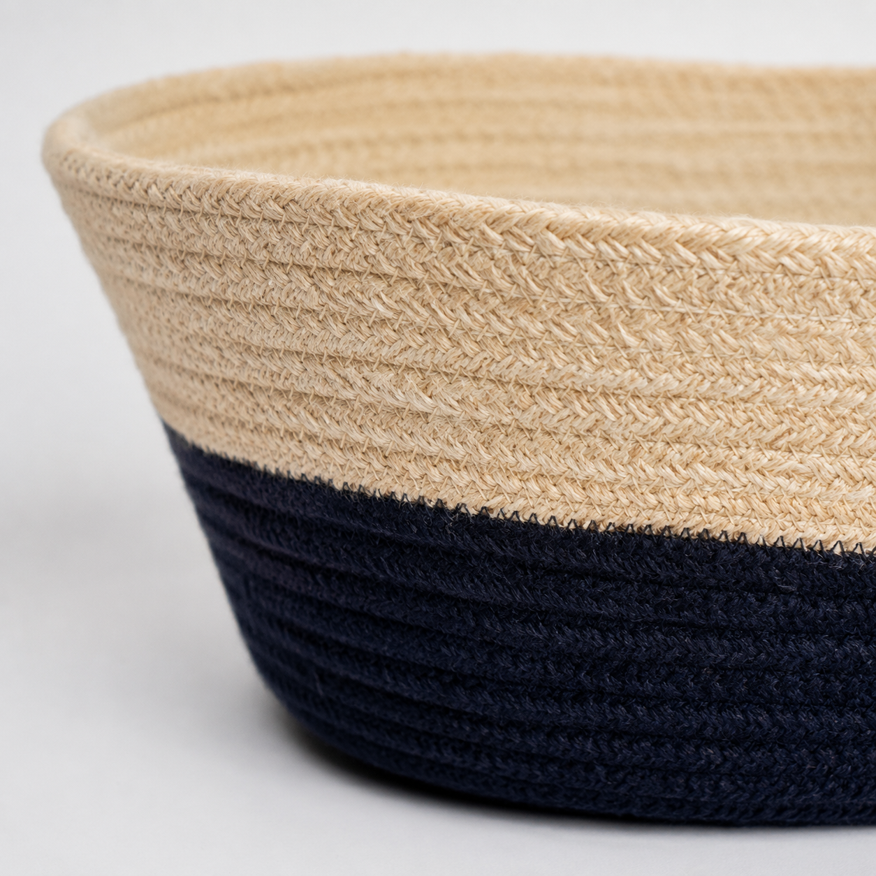 Close-up of beige and black handwoven cotton cord basket texture