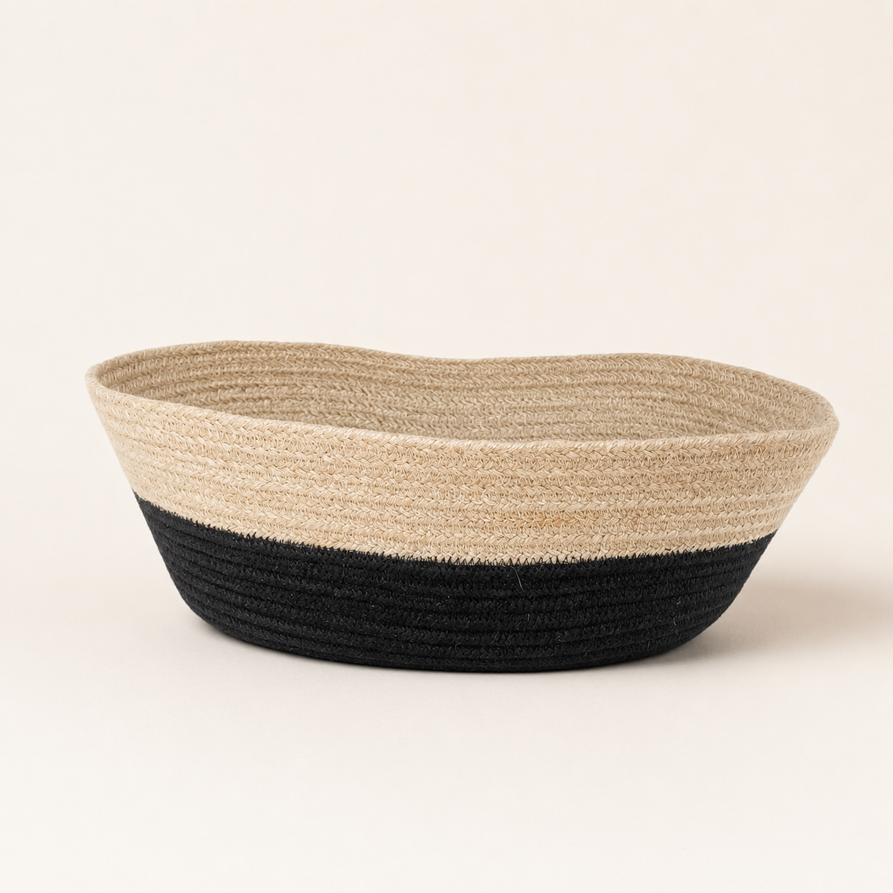 Front view of beige and black handwoven cotton cord fruit basket