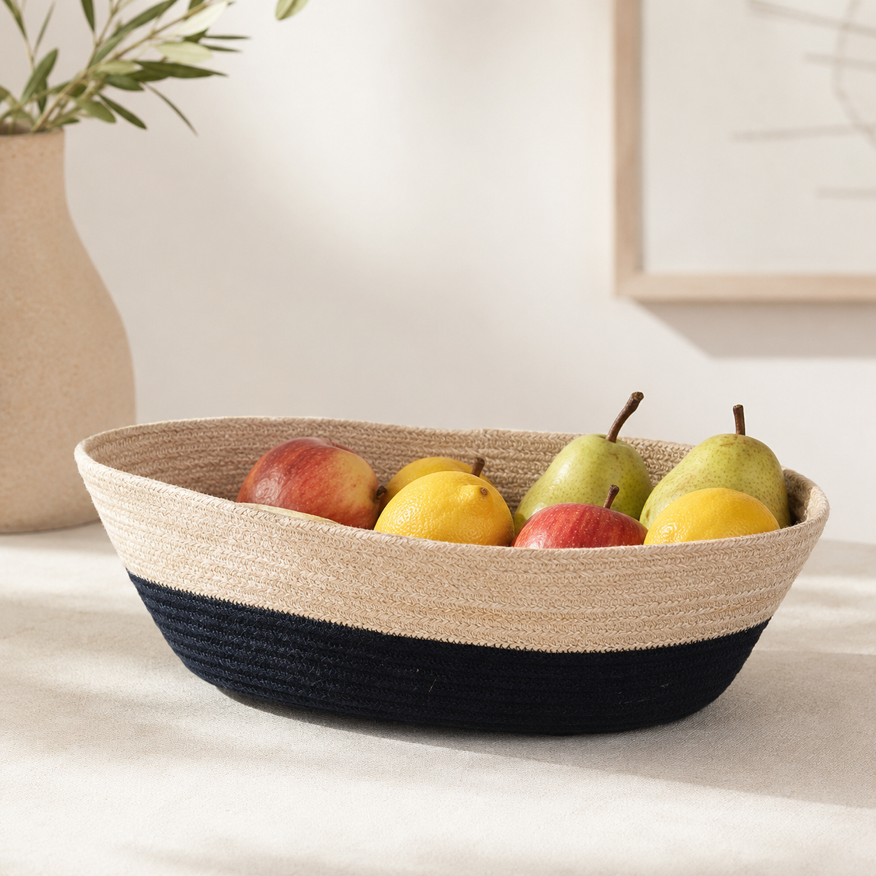 Handwoven beige and black cotton cord fruit basket styled with fresh fruit